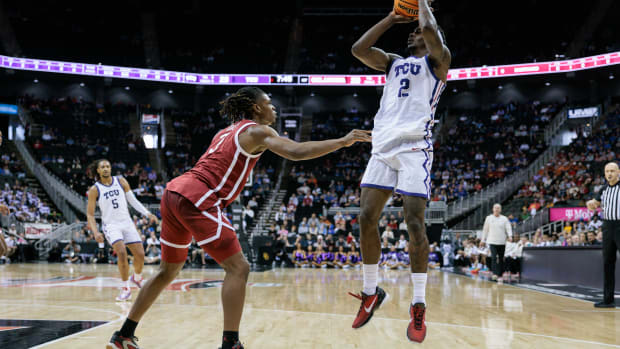 Mar 13, 2024; Kansas City, MO, USA; TCU Horned Frogs forward Emanuel Miller (2) shoots the ball over TCU Horned Frogs guard Avery Anderson III (3) during the first half at T-Mobile Center. 