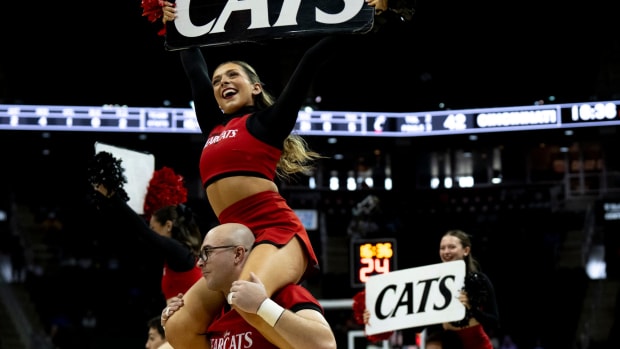 Cincinnati Bearcats cheerleaders perform during a timeout in the second half of the Big 12 Conference tournament between Cincinnati Bearcats and West Virginia Mountaineers at T-Mobile Center in Kansas City, Mo., on Tuesday, March 12, 2024.  