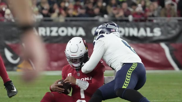 Arizona Cardinals quarterback Kyler Murray (1) is hit by Seattle Seahawks linebacker Devin Bush (0) after sliding during the fourth quarter at State Farm Stadium in Glendale on Jan. 7, 2024.