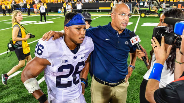 Sep 23, 2017; Iowa City, IA, USA; Penn State Nittany Lions running back Saquon Barkley (26) and head coach James Franklin talk with reporters after the game against the Iowa Hawkeyes at Kinnick Stadium. Penn State won 21-19.