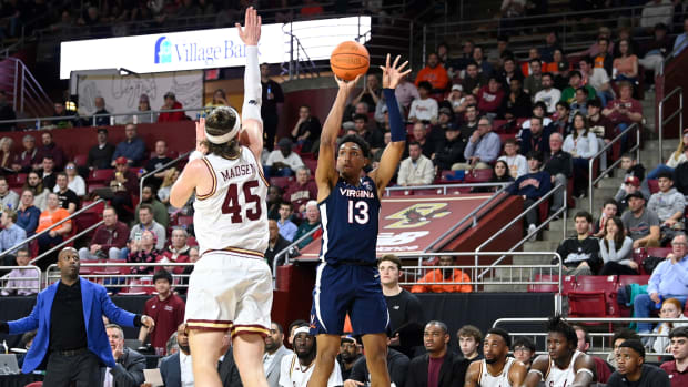 Virginia Cavaliers guard Ryan Dunn (13) shoots the ball over Boston College Eagles guard Mason Madsen (45) during the first half at Conte Forum.