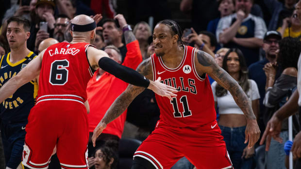Chicago Bulls forward DeMar DeRozan (11) and guard Alex Caruso (6) celebrate a basket to tie the game and go to overtime against the Indiana Pacers at Gainbridge Fieldhouse