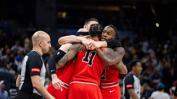  Chicago Bulls team hug after beating the Indiana Pacers in overtime at Gainbridge Fieldhouse.