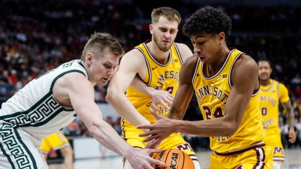 Michigan State forward Jaxon Kohler (0) and Minnesota guard Cam Christie (24) battle for the loose ball during the first half of Second Round of Big Ten tournament at Target Center in Minneapolis on Thursday, March 14, 2024.