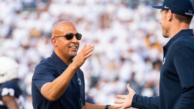Penn State head coach James Franklin greets offensive line coach Phil Trautwein before a 2023 game at Beaver Stadium.