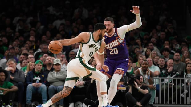 Boston Celtics forward Jayson Tatum (0) controls the ball while Phoenix Suns center Jusuf Nurkic (20) defends during the first half at TD Garden.