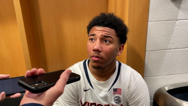 Reece Beekman answers questions from the media in the locker room following Virginia' 66-60 overtime victory over Boston College in the quarterfinals of the 2024 ACC Men's Basketball Tournament at Capital One Arena.