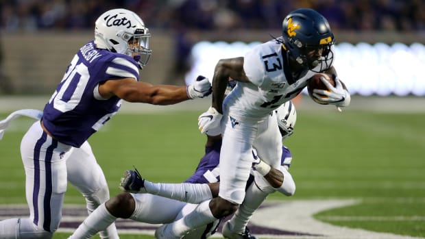 Nov 16, 2019; Manhattan, KS, USA; West Virginia Mountaineers wide receiver Sam James (13) breaks away from Kansas State Wildcats defensive backs Walter Neil Jr. (15) and Denzel Goolsby (20) during the fourth quarter of a game at Bill Snyder Family Stadium. Mandatory Credit: Scott Sewell-USA TODAY Sports  
