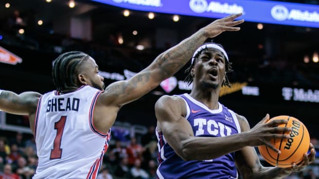 Mar 14, 2024; Kansas City, MO, USA; TCU Horned Frogs forward Emanuel Miller (2) shoots the ball around Houston Cougars guard Jamal Shead (1) during the second half at T-Mobile Center. M