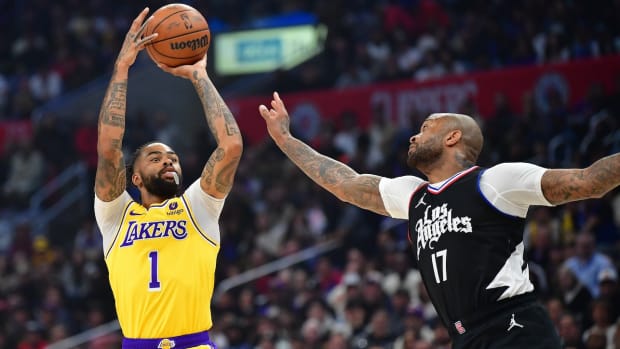 Los Angeles Lakers guard D'Angelo Russell (1) shoots against Los Angeles Clippers forward P.J. Tucker (17) during the first half at Crypto.com Arena in Los Angeles on Feb. 28, 2024.
