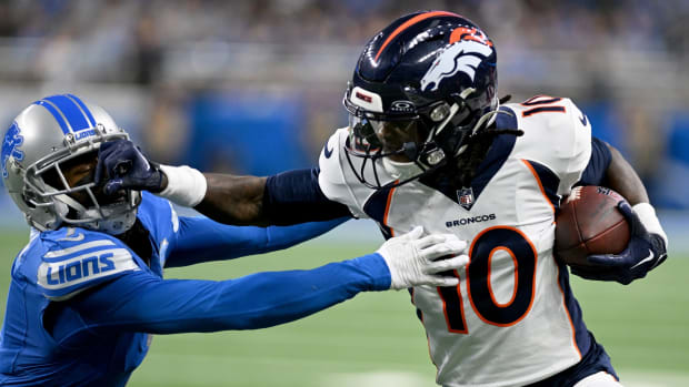 Dec 16, 2023; Detroit, Michigan, USA; Denver Broncos wide receiver Jerry Jeudy (10) stiff arms Detroit Lions cornerback Cameron Sutton (1) in the third quarter at Ford Field. Mandatory Credit: Lon Horwedel-USA TODAY Sports
