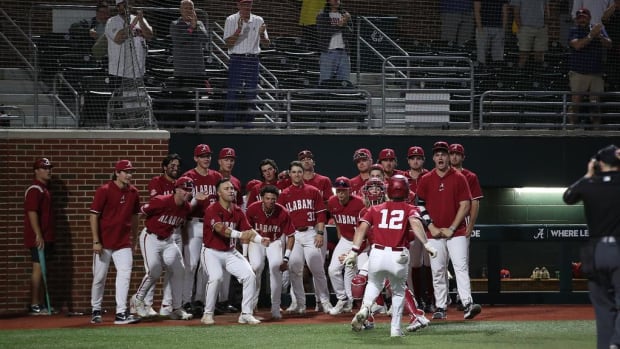 Alabama baseball players celebrate a Gage Miller (12) home run against Troy.