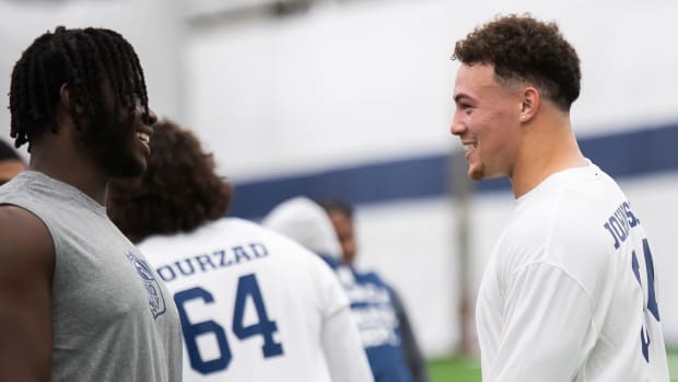 Penn State's Olu Fashanu (left) and Theo Johnson share a laugh at Penn State Pro Day at Holuba Hall in State College.