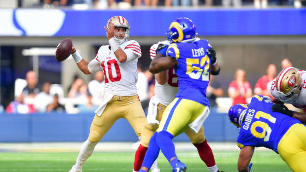Oct 30, 2022; Inglewood, California, USA; San Francisco 49ers quarterback Jimmy Garoppolo (10) throws as Los Angeles Rams linebacker Terrell Lewis (52) moves in during the first half at SoFi Stadium. Mandatory Credit: Gary A. Vasquez-USA TODAY Sports