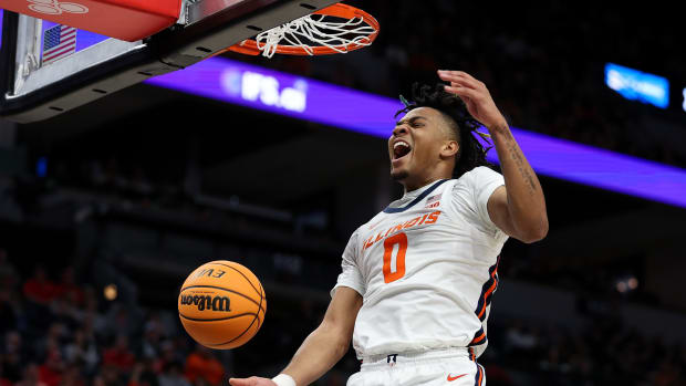 Illinois Fighting Illini guard Terrence Shannon Jr. (0) celebrates his dunk against the Ohio State Buckeyes during the first half at Target Center.