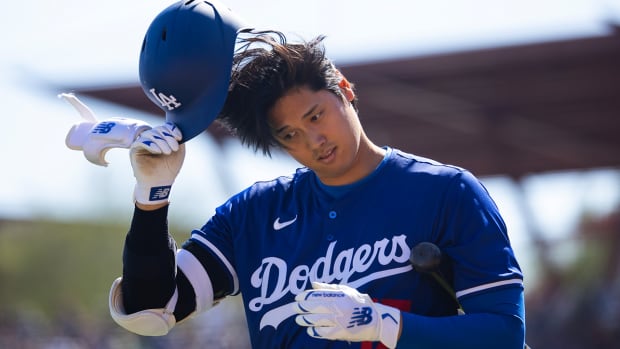 Dodgers’ Shohei Ohtani walks back to the dugout in a Spring Training game.