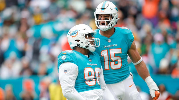 Dec 25, 2022; Miami Gardens, Florida, USA; Miami Dolphins defensive tackle Raekwon Davis (98) celebrates with linebacker Jaelan Phillips (15) after making a play during the second quarter against the Green Bay Packers at Hard Rock Stadium. Mandatory Credit: Sam Navarro-USA TODAY Sports