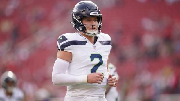 Seahawks quarterback Drew Lock looks on during warmups before a game.