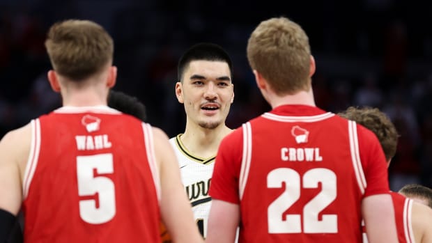 Mar 16, 2024; Minneapolis, MN, USA; Purdue Boilermakers center Zach Edey (15) exchanges words with Wisconsin Badgers players during the first half at Target Center.