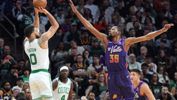 Boston Celtics forward Jayson Tatum (0) shoots over Phoenix Suns forward Kevin Durant (35) during the first half at Footprint Center.