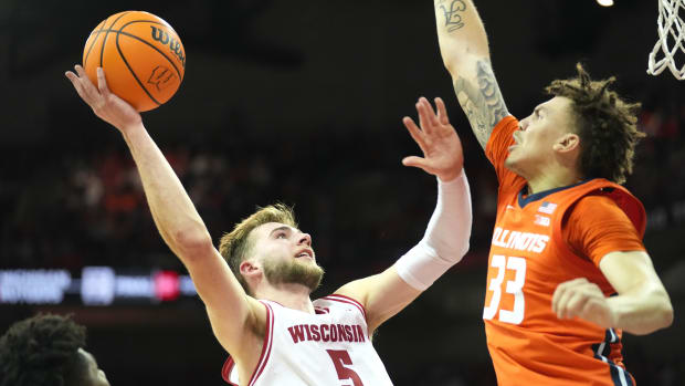 Wisconsin Badgers forward Tyler Wahl (5) scores against Illinois Fighting Illini forward Coleman Hawkins (33) during the second half at the Kohl Center.