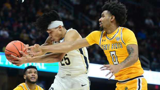 Akron forward Enrique Freeman and Rollins during the Zips’ 62-61 win over Kent State in the MAC tournament championship on March 16, 2024.
