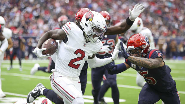 Nov 19, 2023; Houston, Texas, USA; Arizona Cardinals wide receiver Marquise Brown (2) runs with the ball as Houston Texans safety Jalen Pitre (5) attempts to make a tackle during the second quarter at NRG Stadium. Mandatory Credit: Troy Taormina-USA TODAY Sports  
