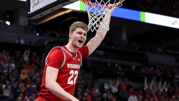 Wisconsin forward Steven Crowl (22) celebrates his dunk against Purdue during the second half at Target Center in Minneapolis on March 16, 2024.