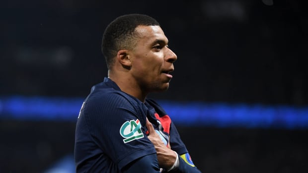 Kylian Mbappe pictured standing with his arms folded while celebrating a goal for Paris Saint-Germain in a 3-1 win over Nice in March 2024
