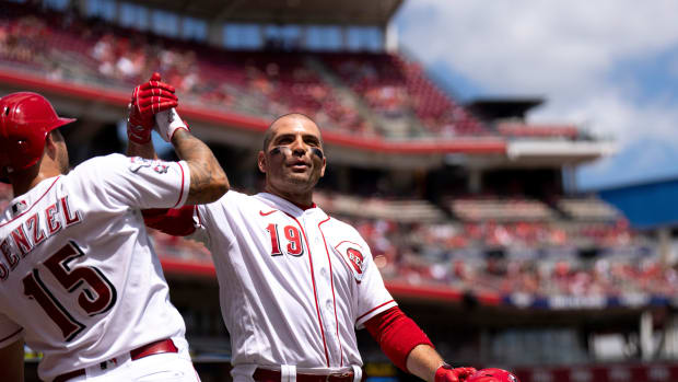 Cincinnati Reds first baseman Joey Votto (19) grabs Cincinnati Reds third baseman Nick Senzel (15) after hitting a solo home run in the second inning of the MLB baseball game between Cincinnati Reds and Washington Nationals at Great American Ball Park in Cincinnati on Sunday, Aug. 6, 2023.