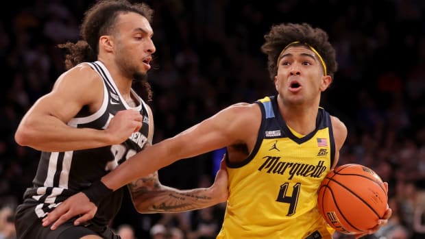 Marquette Golden Eagles guard Stevie Mitchell (4) drives to the basket against Providence Friars guard Devin Carter (22) during the second half at Madison Square Garden in New York City on March 15, 2024.