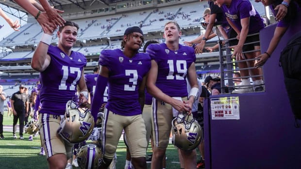 UW wide receiver Rashid Williams (3) leaves the field with quarterbacks Teddy Purcell (17) and Alex Johnson (19).