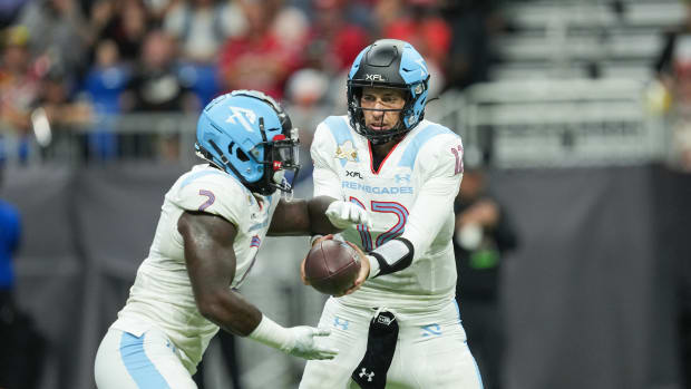 May 13, 2023; San Antonio, TX, USA; Arlington Renegades quarterback Luis Perez (12) hands off to Arlington Renegades running back De Veon Smith (2) in the first half against the DC Defenders at the Alamodome. Mandatory Credit: Daniel Dunn-USA TODAY Sports  