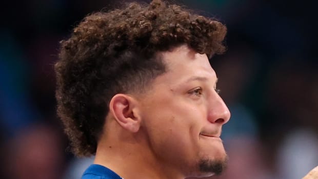 Mar 17, 2024; Dallas, Texas, USA; Kansas City Chiefs quarterback Patrick Mahomes II cheers during the second half of the game between the Dallas Mavericks and Denver Nuggets at American Airlines Center.