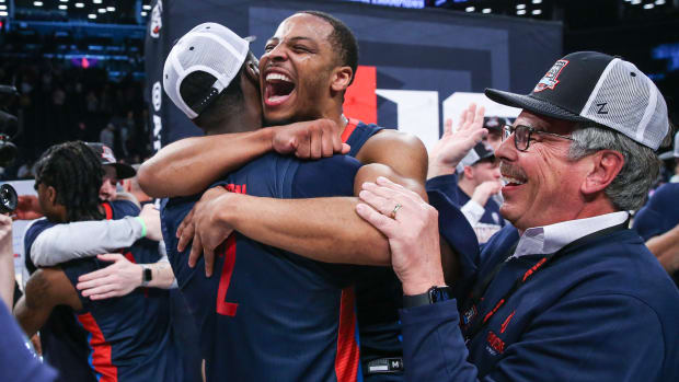Duquesne players celebrate after winning the NCAA tournament