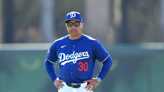 Feb 18, 2024; Glendale, AZ, USA; Los Angeles Dodgers manager Dave Roberts (30) looks on during spring training at Camelback Ranch.
