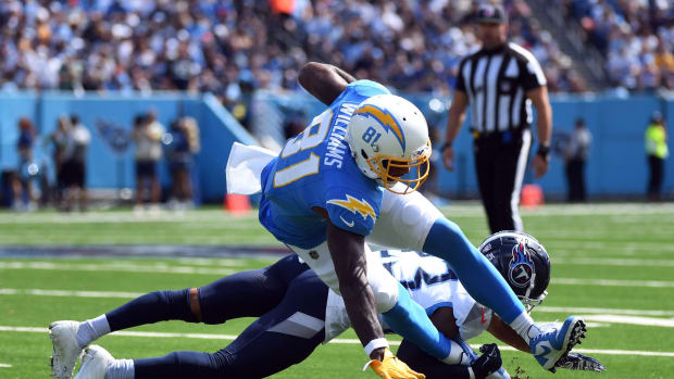 Sep 17, 2023; Nashville, Tennessee, USA; Los Angeles Chargers wide receiver Mike Williams (81) is tackled behind the line by Tennessee Titans cornerback Tre Avery (23) during the first half at Nissan Stadium.