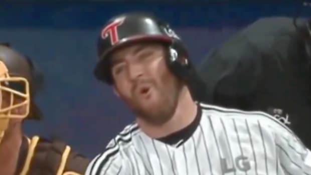 Batter grimaces after swinging and missing at a pitch