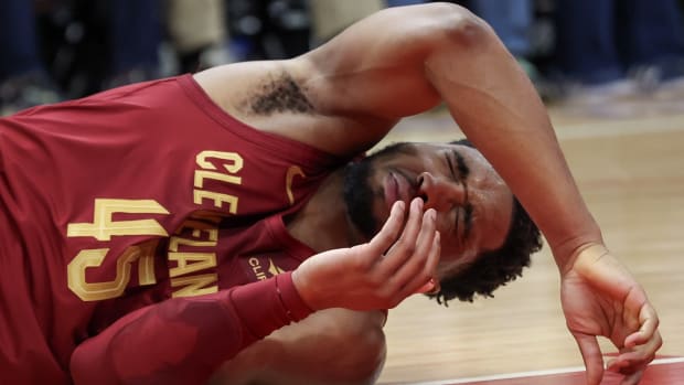 Cleveland Cavaliers guard Donovan Mitchell (45) reacts after teammate Tristan Thompson hit him in the nose with his elbow 