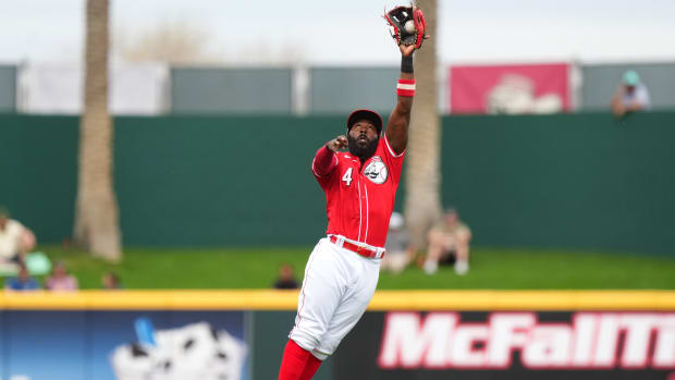 Cincinnati Reds second baseman Josh Harrison leaps to catch a line drive for an out in the first inning during a MLB spring training baseball game against the Seattle Mariners, Monday, Feb. 26, 2024, at Goodyear Ballpark in Goodyear, Ariz.  