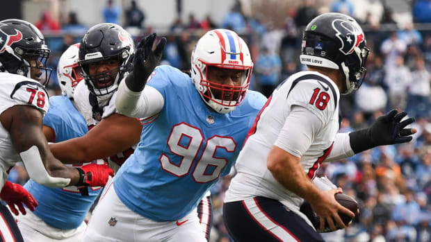 Dec 17, 2023; Nashville, Tennessee, USA; Houston Texans quarterback Case Keenum (18) is sacked by Tennessee Titans defensive end Denico Autry (96) during the second half at Nissan Stadium.