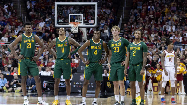 Mar 15, 2024; Kansas City, MO, USA; Baylor Bears watch Iowa State Cyclones shoot a technical free throw during the first half at T-Mobile Center.