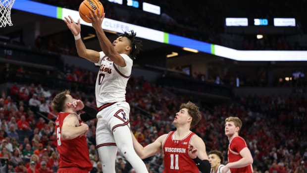 Mar 17, 2024; Minneapolis, MN, USA; Illinois Fighting Illini guard Terrence Shannon Jr. (0) goes to the basket over Wisconsin Badgers forward Tyler Wahl (5) in the second half at Target Center.