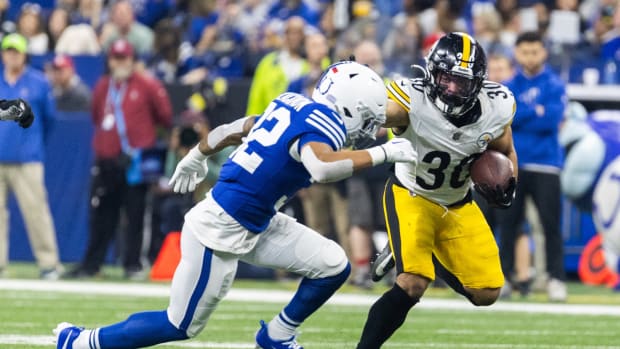 Dec 16, 2023; Indianapolis, Indiana, USA; Pittsburgh Steelers running back Jaylen Warren (30) runs the ball while Indianapolis Colts safety Julian Blackmon (32) defends in the first half at Lucas Oil Stadium.