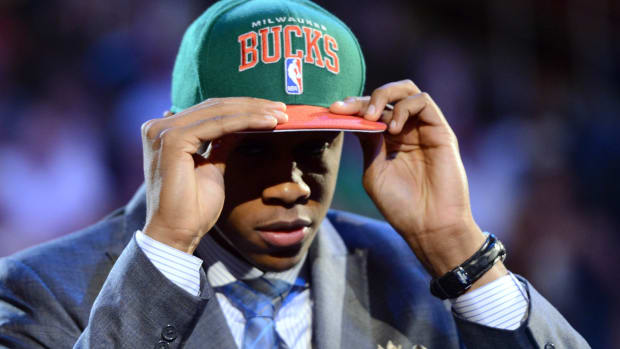 John Henson (North Carolina) puts on a cap after being introduced as the number fourteen overall pick to the Milwaukee Bucks during the 2012 NBA Draft 