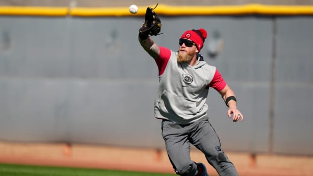 Cincinnati Reds right fielder Jake Fraley (27) completes a catch in the outfield during spring training workouts, Thursday, Feb. 15, 2024, at the team s spring training facility in Goodyear, Ariz.  