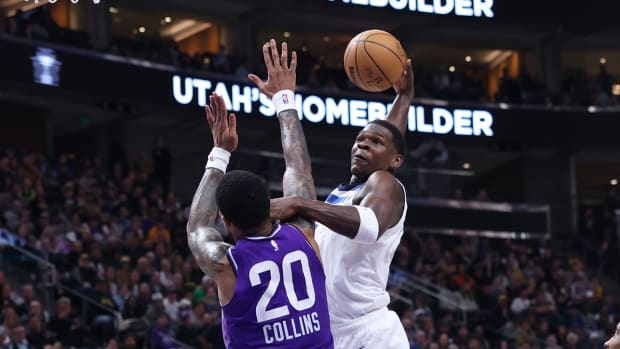 Minnesota Timberwolves star Anthony Edwards dunks over Utah Jazz forward John Collins.