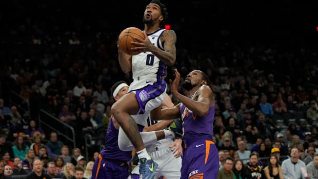 Sacramento Kings guard Malik Monk (0) drives on Phoenix Suns forward Kevin Durant (35) in the second half at Footprint Center.