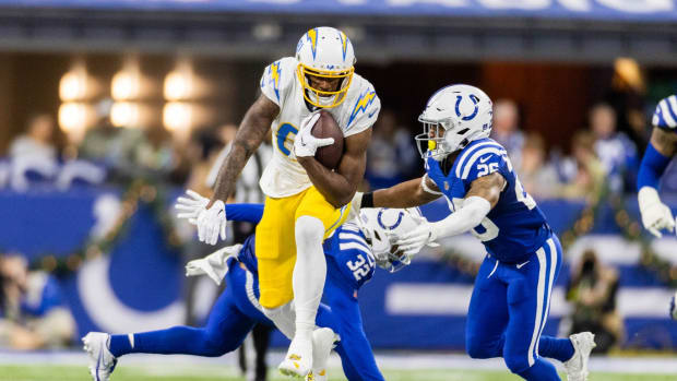 Dec 26, 2022; Indianapolis, Indiana, USA; Los Angeles Chargers wide receiver Mike Williams (81) runs the ball while Indianapolis Colts safety Rodney Thomas II (25) defends in the second half at Lucas Oil Stadium.