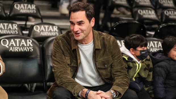 Roger Federer sitting courtside at an NBA game